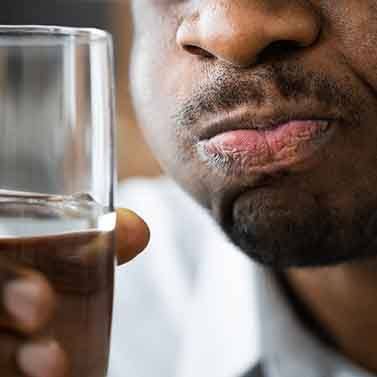 a man rinsing his mouth with salt water